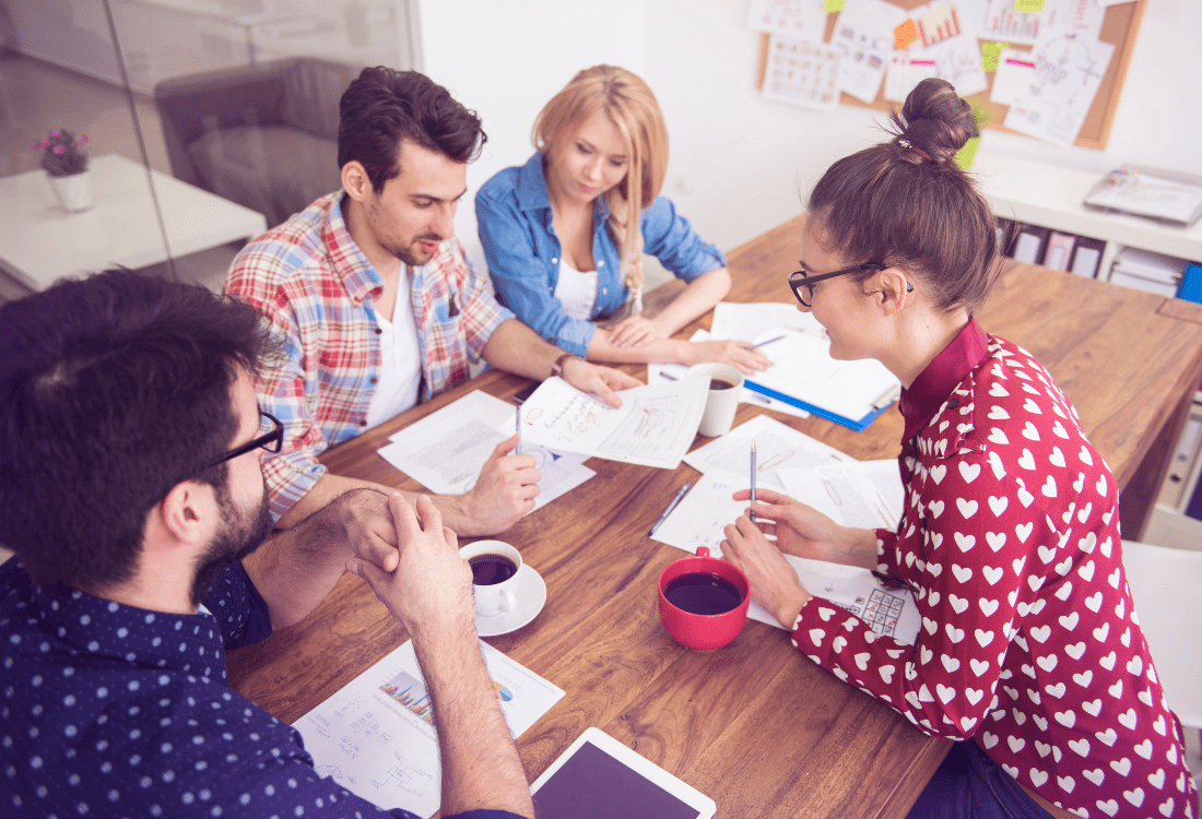 A focus group sat around a table gathering their ideas and thoughts to help with the luxury app development process.